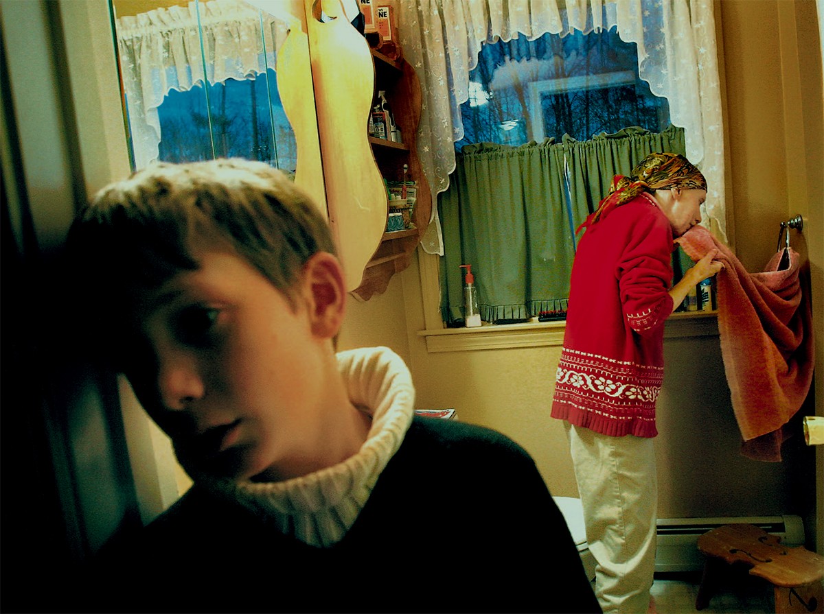 Brian stands at the bathroom while his mother cleans up after a bout of nausea. "I just see so much wear and tear on the family unit," said Carolynne's sister Sara Matters. (1/13/07)