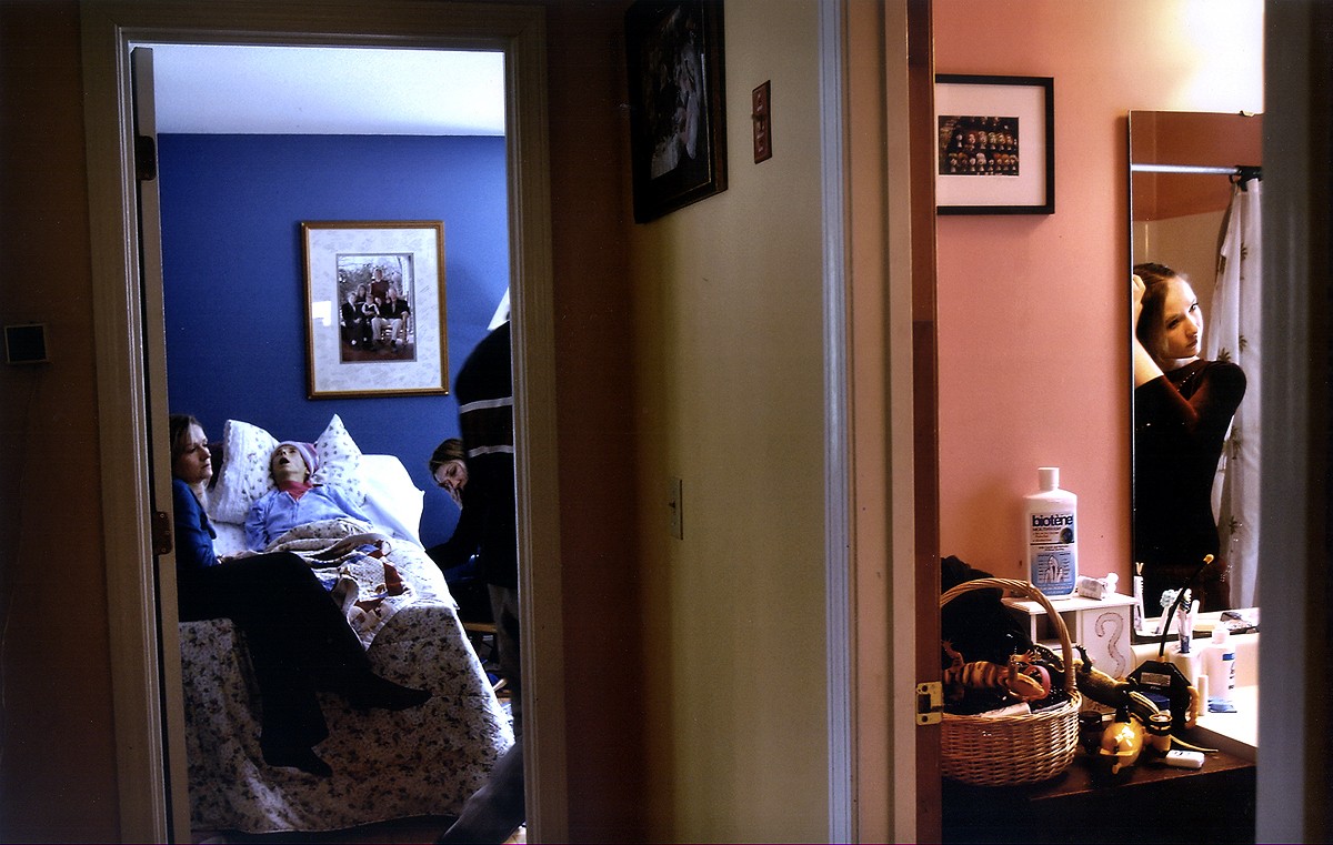 Melissa braids her hair while getting ready for her state gymnastics meet as family members sit with Carolynne. As her mother got sicker, Melissa spent less time at home. Fearing that Carolynne would die that day, Rich debated but decided to let Melissa continue with her plans. (2/13/07)