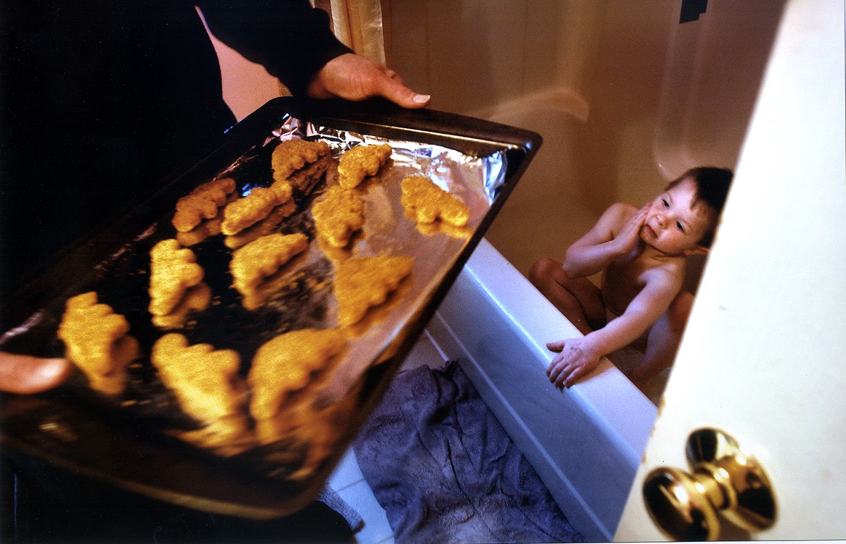 At EJ's request, Rich brings the dinosaur-shaped chicken nuggets into the bathroom where EJ can see them.