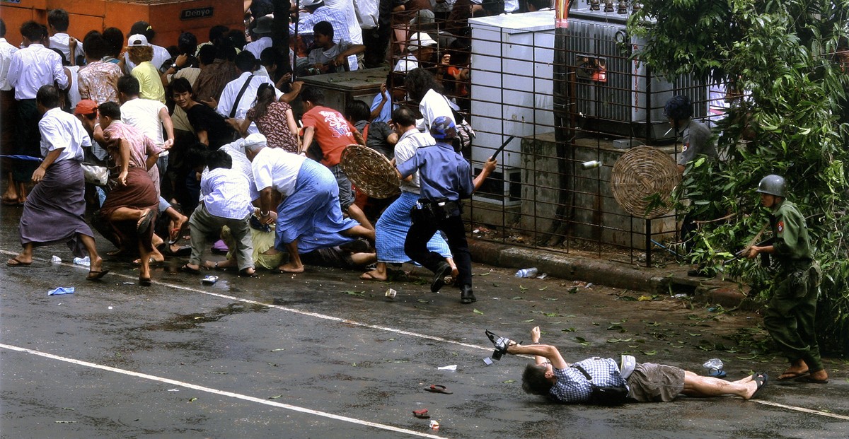 A wounded Japanese photographer, Kenji Nagai, lay before a Burmese soldier yesterday in Yangon, Myanmar, as troops attacked protesters. Mr. Nagai later died. 