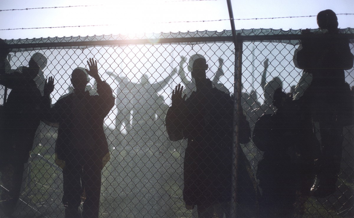A crowd of children waited behind a fence on the track at Duncanville High School in Duncanville, Tex. as Senator Obama arrived to speak.