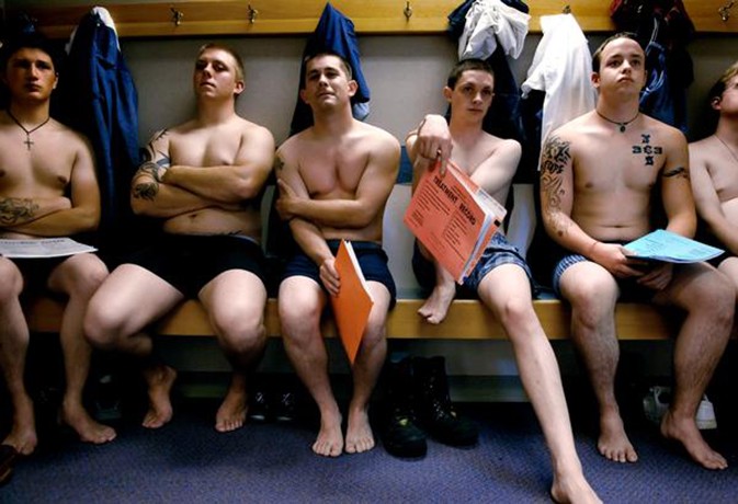 Fisher, second from right, waits for a medical exam with other recruits at the Denver Military Entrance Processing Station on June 18, 2007.  They took the oath of enlistment and, later that day, Fisher would travel to Fort Benning, where his new life in the Army began.  Over the next three days, he filled out forms.  He stood in formation.  And he joined in the constant repetition of the Soldier’s Creed:  "...I will always place the mission first; I will never accept defeat; I will never quit; I will 