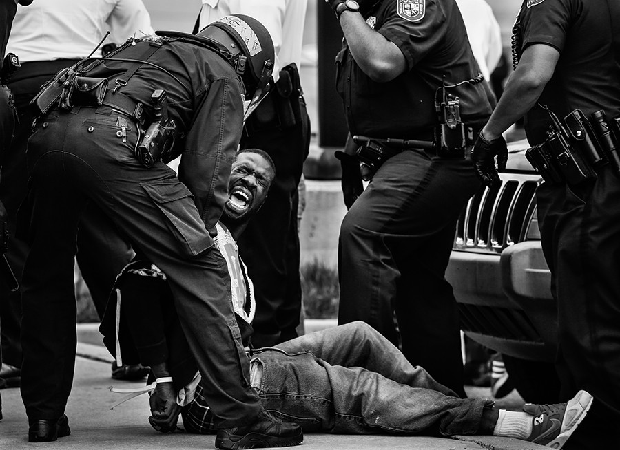 Baltimore Police officers arrest a man near Mowdamin Mall in Baltimore, Maryland. The funeral service for Freddie Gray, who died last week while in Baltimore Police custody, was held on Monday morning (Drew Angerer, Getty Images - April 27, 2015).