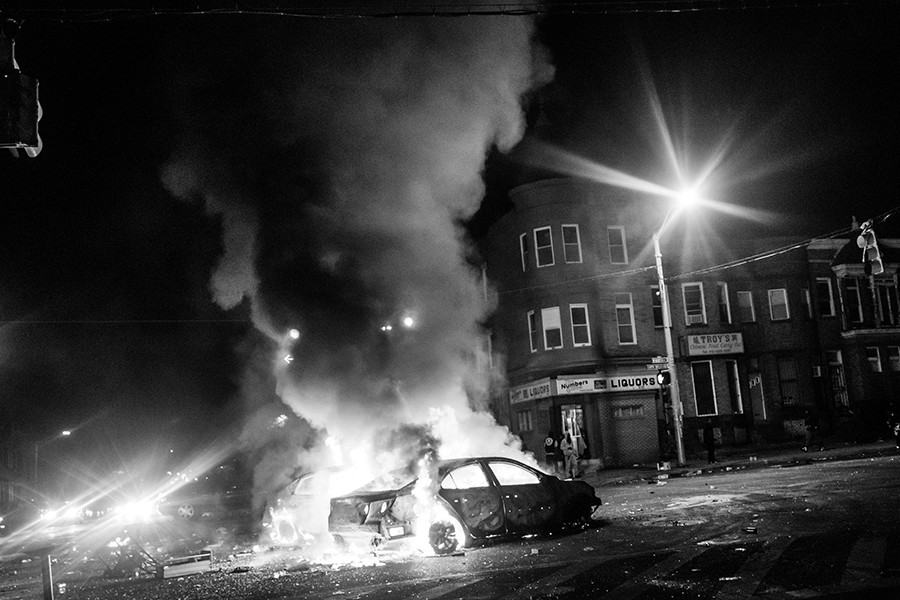 Two cars burn in the middle of an intersection at New Shiloh Baptist Church in Baltimore, Maryland. Riots have erupted in Baltimore following the funeral service for Freddie Gray, who died last week while in Baltimore Police custody (Andrew Burton, Getty Images - April 27, 2015).