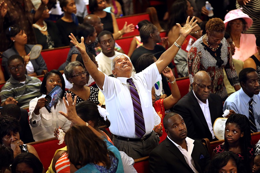 Jimmy Guyton stands in praise to sing at Emanuel AME Church on after the church reopened for the first service since its pastor, state Sen. Clementa Pinckney, and eight others were slain four days earlier during a Bible study. Guyton drove three hours from Greenville, S.C., to attend the service and honor Myra Thompson, who was among those killed (Paul Zoeller, The Post and Courier - June 21, 2015).