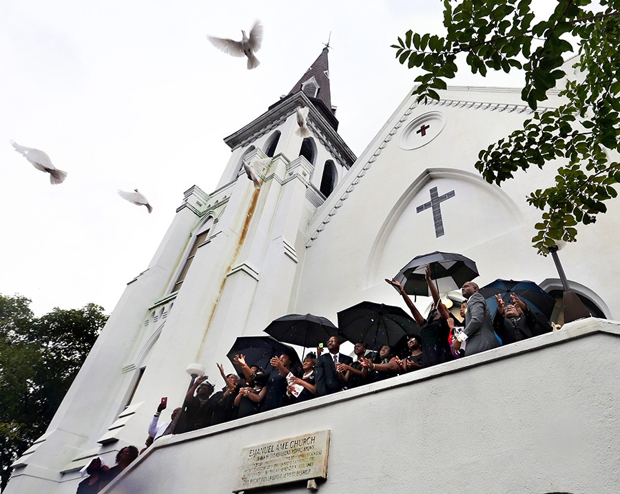 At the close of her funeral, the Rev. DePayne Middleton Doctor’s four daughters and other family members release nine doves from Emanuel AME Church. Doctor was among nine people fatally shot during a Bible study at the church on June 17 (Wade Spees, The Post and Courier - June 28, 2015).