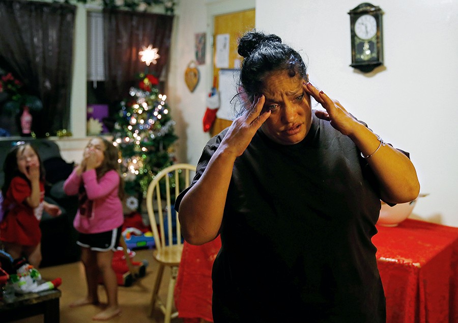High on heroin, Raquel Rodriguez reacts as her daughters, Estrella and Mimi, run back and forth across her small living room. Tomorrow, Raquel will go to the clinic and get her first dose of methadone, but tonight she worries that she won’t be able to do it (Jessica Rinaldi, The Boston Globe).