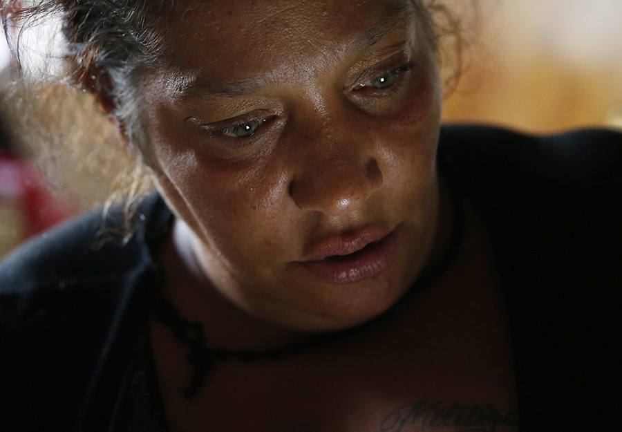 High on heroin, Raquel checks Facebook on her phone moments after writing a post asking for help to find a new apartment. "I am in desperate need of all the help I can get. I have two children ages 4 and 6," she wrote, "and am a recovering addict struggling everyday to move forward for my children." (Jessica Rinaldi, The Boston Globe).