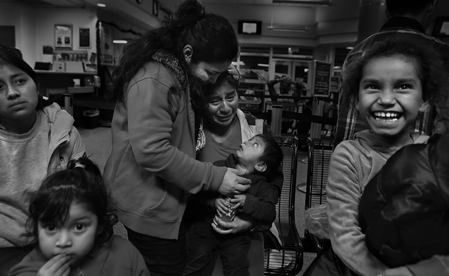 With a mixture of joy, laughter, tears and befuddlement, Lisvette Sanches Rodriguez, center, of El Salvador, comforts a grateful Vina Lopez, of Guatemala, with her two year old son, after a group of 11 immigrants from Central America were given food and clothing by members of the Interfaith Welcome Coalition, following their release from the Karnes County Residential Center on Thursday, Dec. 18, 2014. The Interfaith Welcome Coalition also found housing for them so they didn't have to spend the night at the 