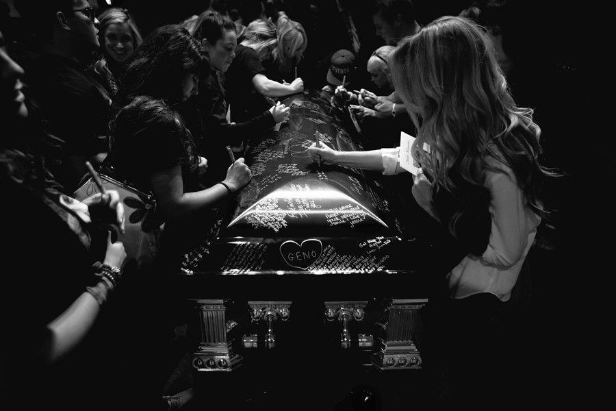 Friends and family sign Austin Klimusko's casket at his funeral in Simi Valley. (December 31, 2012)