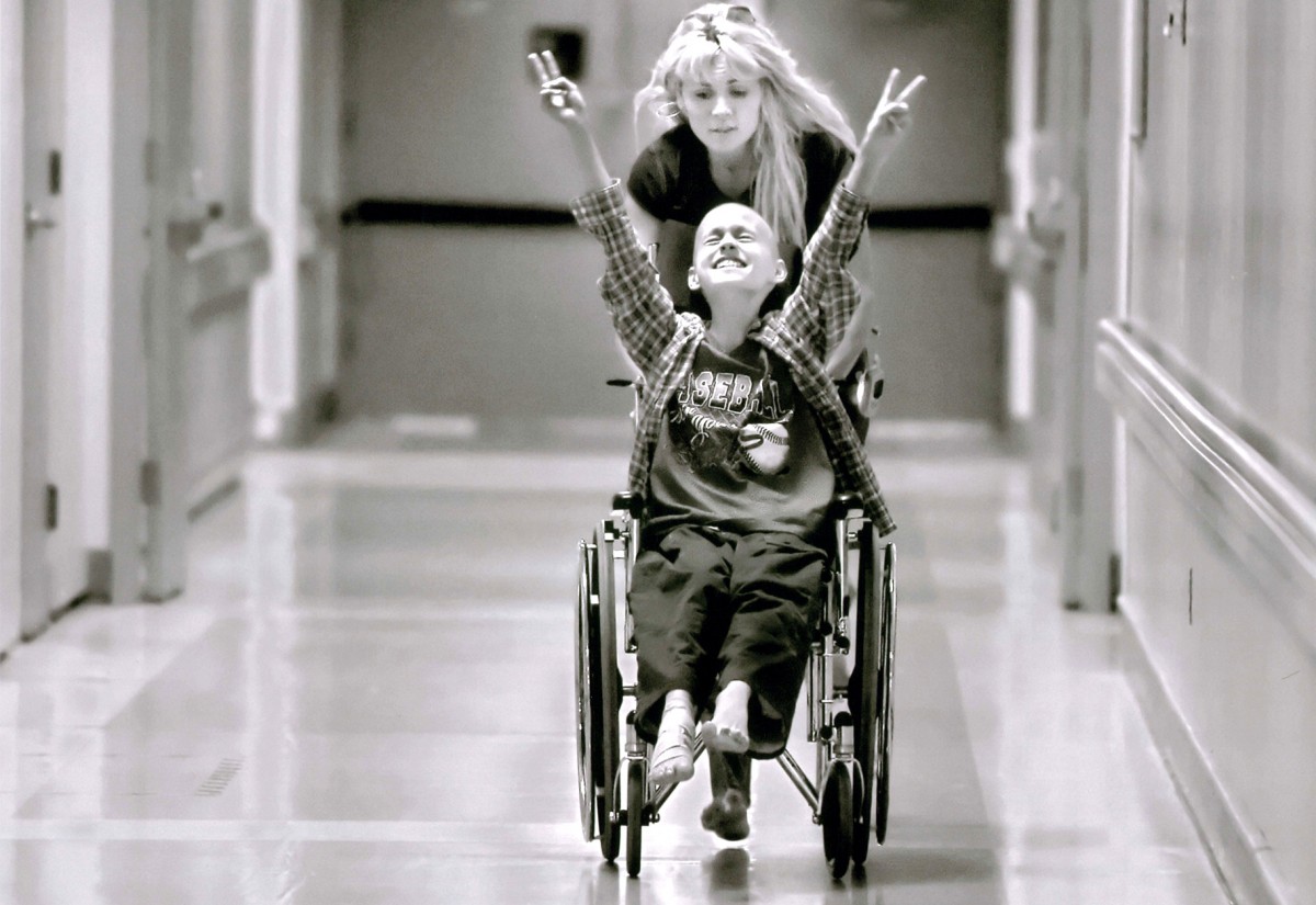 Racing barefooted after kicking off her flip-flops, Cyndie pushes her son Derek Madsen, 10, up and down hallways in the UC Davis Medical Center in Sacramento on June 21, 2005, successfully distracting him during the dreaded wait before his bone marrow extraction. Doctors want to determine whether he is eligible for a blood stem cell transplant, his best hope for beating neuroblastoma, a rare childhood cancer, which was diagnosed in November 2004.