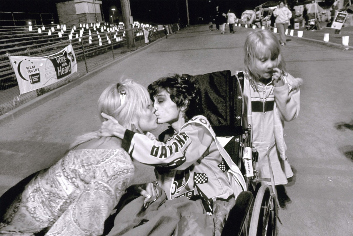 Derek kisses his mom at the Relay for Life benefit, as his 6-year-old sister, Brianna, stands by. Wanting to contribute something to the cause and to "give back," Cyndie recruited volunteers for the benefit. Before the race, Cyndie speaks to the crowd about her pride in her son's bravery during his battle with cancer.