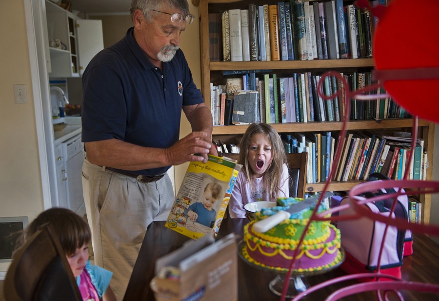 Don Hatfield opens a box of cereal for his granddaughters as he readies them for their first day of school before Alex's babysitter arrives.  (May 16, 2012)