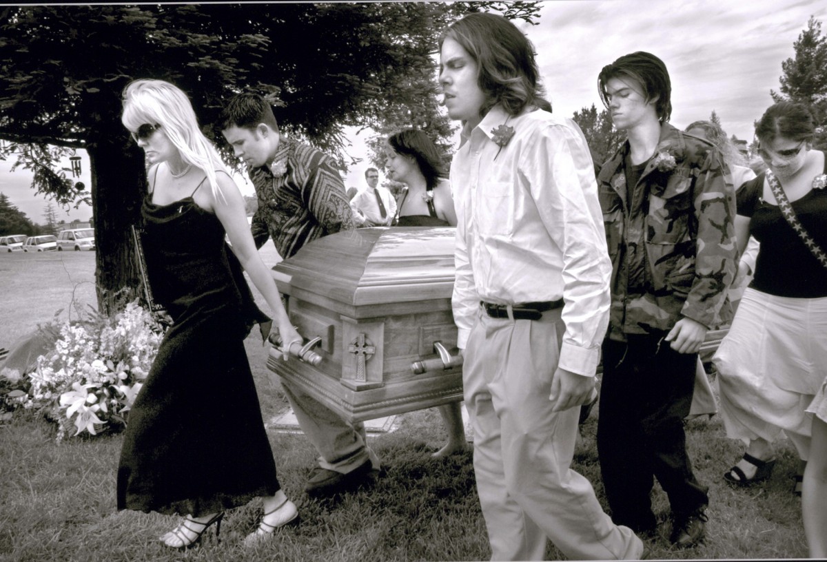 Cyndie leads Derek's casket to burial with assistance from her sons Anthony Moffe, foreground, Micah Moffe, opposite him, and Vincent Morris, who is not visible, as well as several friends. "I will forever carry your memory in my heart and remind others to give of their time, energy and support to other families like ours," Cyndie says at the funeral. Derek was buried in Mount Vernon Memorial Park in Fair Oaks, California, on May 19, 2006.