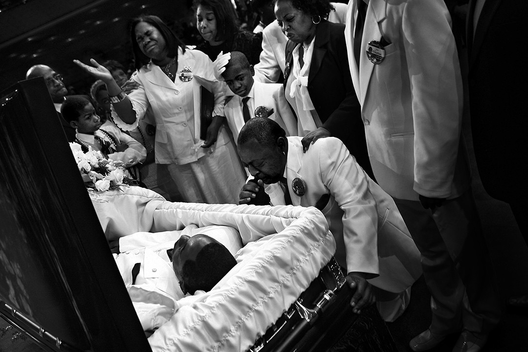 Jamiel Shaw Sr. kneels before his son's coffin during funeral services. Standing, from left, are Jamiel Jr's, mother, Anita Shaw; his brother, Thomas; and aunt Althea Shaw. 'To see my son lying there dead in a casket to be shot, slaughtered  like a dog it makes you want to go out there and just round up everybody that's in a gang and makes you want to be a crime fighter.'  On the same day as Jas' funeral, 19-year-old Pedro Espinoza was formally charged in the teens slaying. (Barbara Davidson, Los Angeles Ti