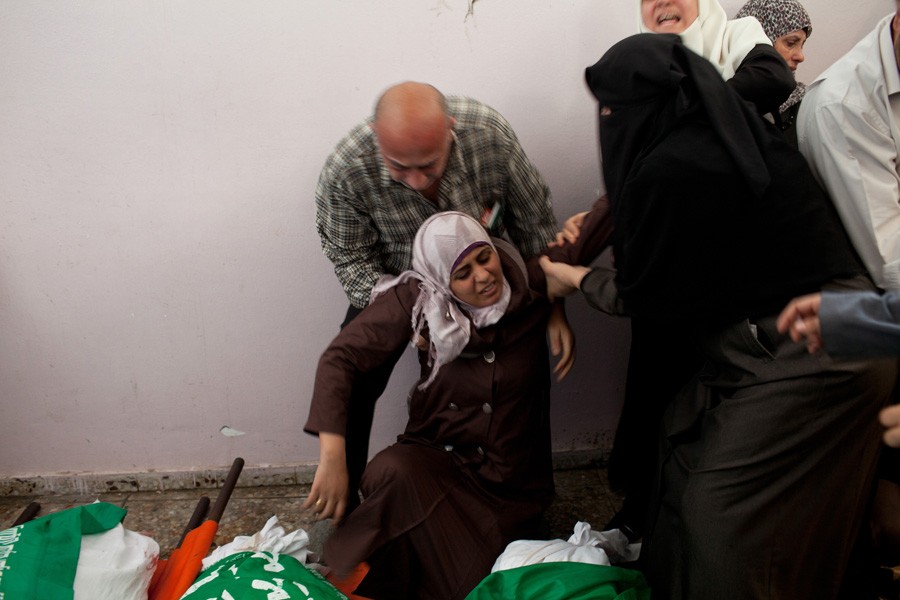 A mourner overwhelmed at the funeral. (November 19, 2012)