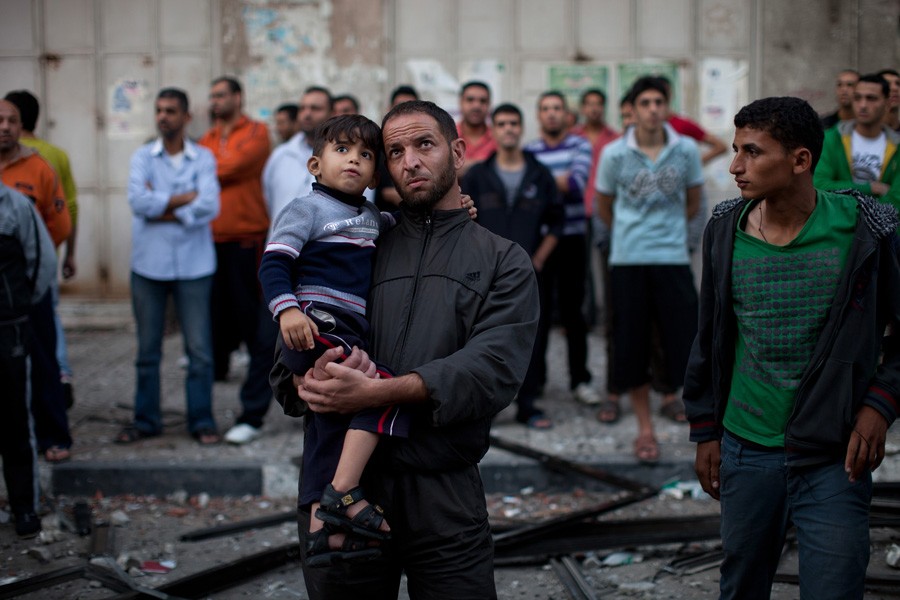 Onlookers at a high-rise building that includes offices for media, after it was struck by an Israeli bomb. (November 19, 2012)