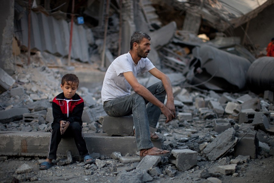 A man and boy amid the rubble of a destroyed home in Gaza. (November 26, 2012)