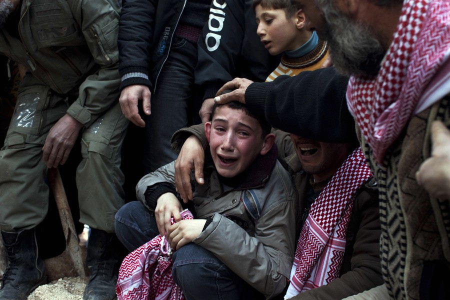 A boy named Ahmed mourns his father, Abdulaziz Abu Ahmed Khrer, who was killed by a Syrian army sniper, during his funeral in Idlib, northern Syria, March 8, 2012. (Rodrigo Abd, Associated Press - March 8, 2012)