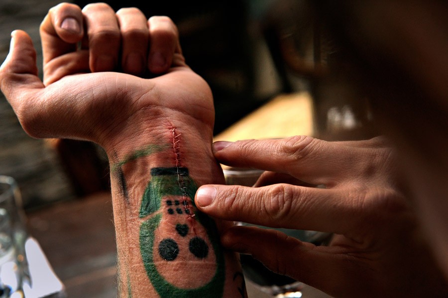 Scott counts the stitches in his wrist a few days after he attempted suicide. Scott said many times he should have died overseas, and during a fight with his girlfriend, she agreed. 'I just grabbed a pair of scissors tried jabbing them into my neck, but they were closed,' Scott said. 'So I grabbed a nice kitchen knife and cut my wrists.' He said he believes every combat vet struggling with PTSD has a contingency plan. 'Every one of us has a suicide plan. We all know how to kill, and we all have a plan to ki