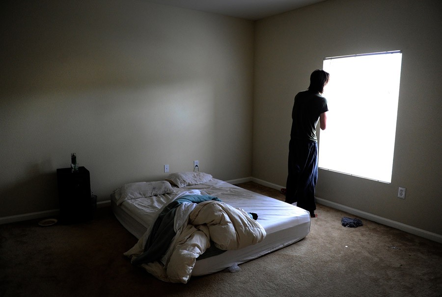 After a sleepless night, Scott stares out the window of his new apartment, in Broomfield, Colo. 'I decided to move because there were too many bad memories at that apartment. I was arrested twice, there's blood all over the bathroom floor, it was small, it was loud,' Scott said. He hoped for a fresh start, but just two weeks later his old feelings had resurfaced. (Craig F. Walker, The Denver Post- December 29, 2011)