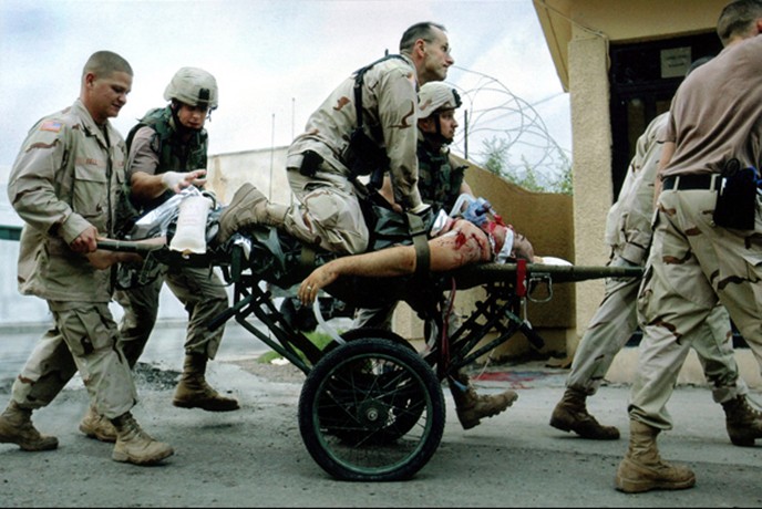 Baghdad - Nurse supervisor Patrick McAndrew kneels over Army Spc. Travis S. Babbit, 24, administering CPR upon arrival at the 31st Combat Support Hospital. Spc. Babbit, of Uvalde, Texas, later died of his wounds. His patrol was attacked in Baghdad by a rocket-propelled grenade and small arms fire, the Pentagon said. 