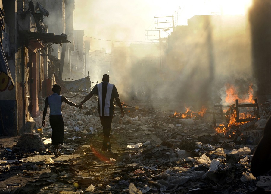 'Life Amid the Ruins'  A couple holds hands and walks amid the wreckage of their country's wounded landscape. Experts familiar with the rebuilding efforts in Haiti say relief work is finally speeding up under the guidance of the Interim Haiti Recovery Commission. The group has set a goal of removing 40 percent of the earthquake rubble by October and has approved projects such as highways, apartment buildings and 250 temporary schools for children. But even with these projects underway, rebuilding Haiti will